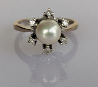 A pearl and diamond cluster ring on a white gold setting, hallmarked 18ct, size N, 4.88g