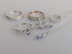 A 9ct white gold diamond and topaz parure comprising a matching pendant chain, earrings and ring