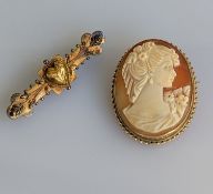 An Etruscan-style gold brooch with carved central heart motif, 45mm, stamped 15ct, 3.4g, and an oval