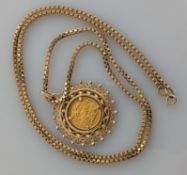 An Edwardian gold half-sovereign, 1905, on a 9ct gold pierced mount and box-link chain, hallmarked