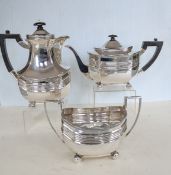 An Edwardian silver three-piece tea service comprising teapot, water jug and twin-handled sugar bowl