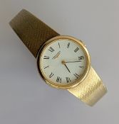A vintage ladies Longines manual wristwatch with Roman numerals on a white dial, gold case