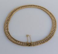 A mid-century yellow gold fancy-link necklace, 42 cm, import marks for 9ct gold, 32g