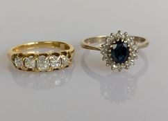 A five-stone graduated diamond ring on a yellow gold setting, the largest cushion-cut diamond 