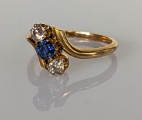 A Victorian diamond and sapphire three-stone crossover ring on a yellow gold setting, size P,