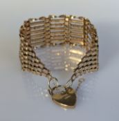 A yellow gold gate-link cuff bracelet with heart-shape clasp, hallmarked 9ct, 17cm, 16.3g