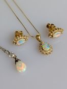 An Italian tear drop opal cluster pendant (7 x 5mm) chain with diamond decoration on a claw-set yell