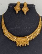 An Indian gold choker with elaborate pierced and bead decoration with matching earrings, stamped 916
