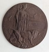 A WWI bronze memorial plaque, colloquially known as a Death Penny or Dead Man's Penny,