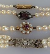 An Art Deco three-strand pearl choker, the graduated beads measuring 3-8mm, the white metal clasp 