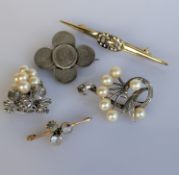 A moonstone and emerald brooch on a gold setting, 40mm, stamped 9ct, 2.7g; two silver-based pearl 