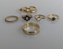A white and yellow gold spinning ring with etched decoration, stamped 585, size X, 5g, and four othe