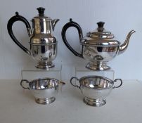 An Art Deco four-piece silver tea and coffee service with decorative girdle/rim and Bakelite handles