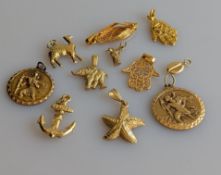 Two yellow gold charms or pendants of a star fish and anchor, both stamped 14k, 4.8g; two St. Christ