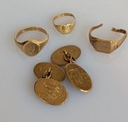 A pair of oval gold cufflinks, initialled; a yellow gold signet ring, another smaller and one with c