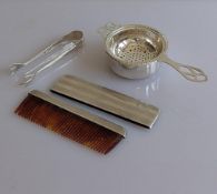 A George V silver cased comb with Greek-key engine turned decoration, import marks for 1926, 11 cm;