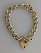 A yellow gold curb-link bracelet with heart-shape clasp, 19 cm, hallmarked 9ct, 11.8g