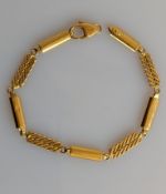 An Italian yellow gold baton and fancy-link design bracelet, lobster clasp broken, 20 cm, stamped 75