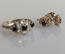 A diamond and sapphire cluster ring on an 18ct white gold claw setting with similar earrings, size O