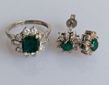 An Art Deco-style emerald and diamond cluster ring with similar earrings on an 18ct white gold setti