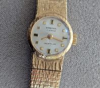 A ladies Romana manual wristwatch with square gold markers on a circular white dial, gold case