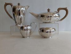 An Art Deco silver four-piece tea service comprising tea pot of squat form with lobed decoration, ho
