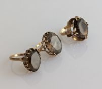 Three vintage smokey topaz dress rings on 9ct yellow gold claw settings, all hallmarked