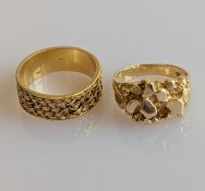 Two yellow gold rings with elaborately carved decoration, one 18ct, 4.7g, the other 14ct, 5g