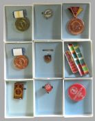 9 diverse Orden und Abzeichen, DDR.