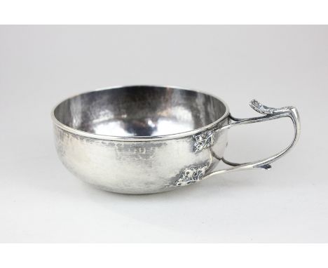 An Edwardian silver bowl with hammered effect and Art Nouveau side handle, maker GH Ltd, London 1907