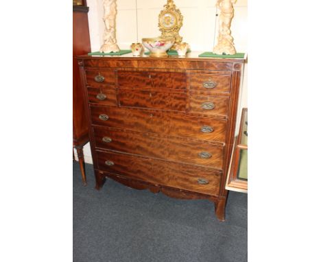 A Victorian walnut secretaire chest with central secretaire drawer, enclosing fitted small drawers and pigeon holes flanked b