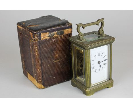 A brass and bevelled glass cased carriage clock with Roman numerals on white enamel face, in leather travelling case with key