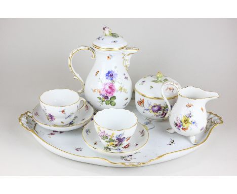 A Meissen porcelain cabaret set comprising coffee jug, sugar bowl and cover, cream jug, two cups and saucers and oval serving