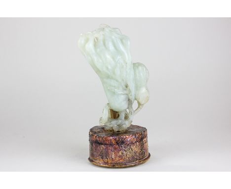 A Chinese carved jade lotus flower on later circular stand, 15cm, (NC)