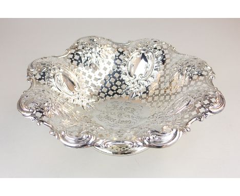 A Victorian silver pedestal dish with pierced decoration, embossed with panels of scrolls and flowers, engraved initials and 