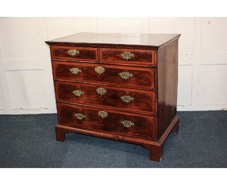 An 18th century walnut chest of two short over three long drawers, with herringbone inlaid top and drawer fronts, on bracket 
