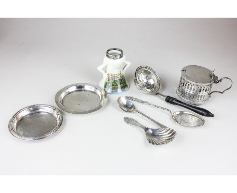 An Edward VII silver caddy spoon, a silver strainer, two silver dishes, a silver mustard (no liner), two silver spoons and a 