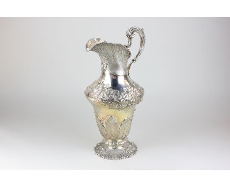 A George IV silver ewer with embossed vine and acanthus leaf decoration, with coat of arms, by Charles Thomas Fox, London 182