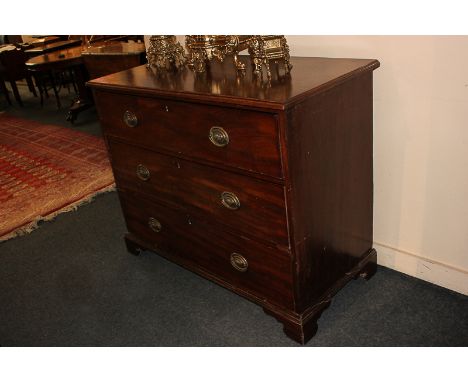 A 19th century mahogany chest of three graduated drawers with oval brass drop handles, on bracket feet, 110cm