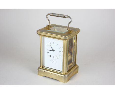 A gilt brass and bevelled glass cased carriage clock by Garrard & Co, London W1, the white enamel dial with Roman numerals, s