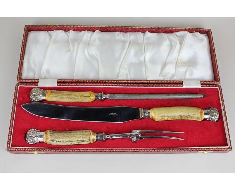 A Harrods, London, three-piece carving set of fork, knife and sharpener, with horn handles, in fitted case