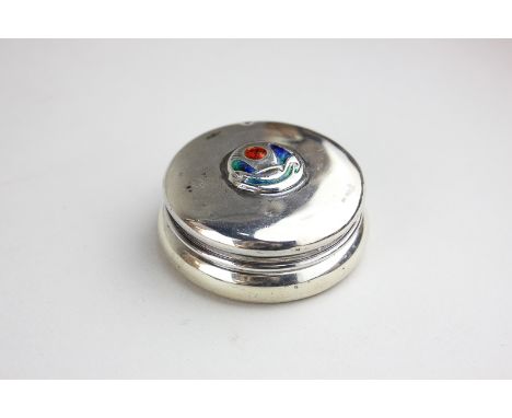 A Liberty & Co Cymric silver and enamel dressing table box, circular shape, top with central coloured enamel motif, maker Lib