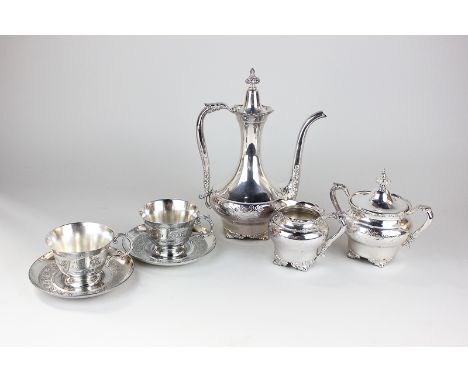 A silver plated Indian style coffee set for two with coffee pot, cream jug, sugar bowl and two teacups and saucers