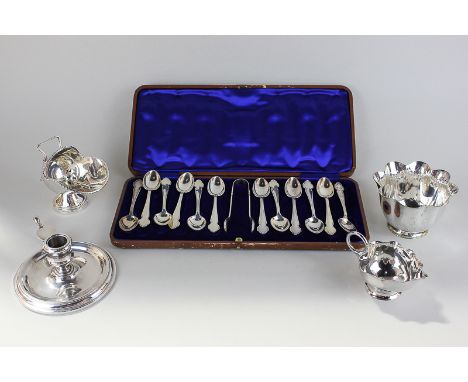 A cased set of twelve silver plated teaspoons with tongs, a chamber stick, a matching sugar bowl and milk jug, and a salt cel