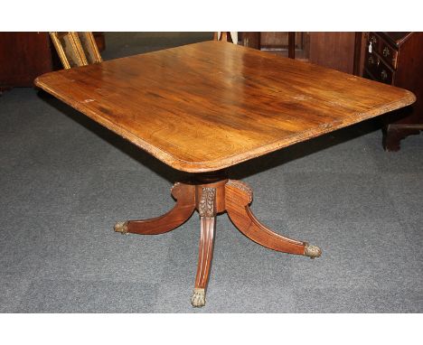 A 19th century mahogany rectangular table with associated reeded pedestal support and four acanthus carved legs on brass paw 