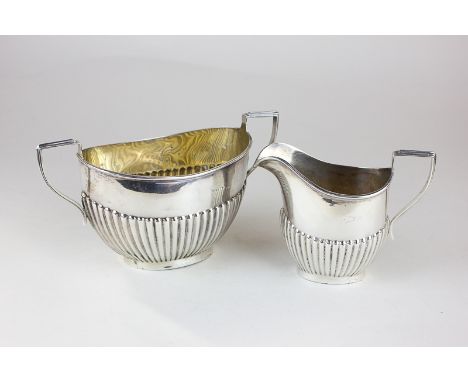 A George V silver cream jug and sugar bowl, Birmingham 1911, with half reeded bodies, 6oz