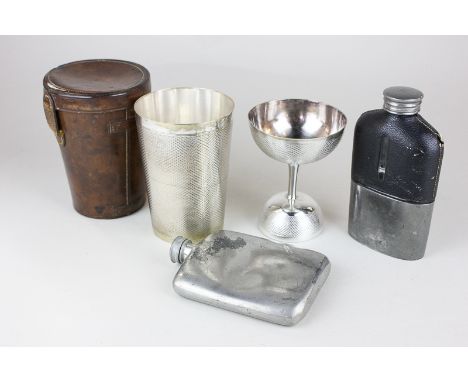 A silver plated beaker in leather case, monogrammed, a double ended cup, a silver plated glass and leather hip flask with int