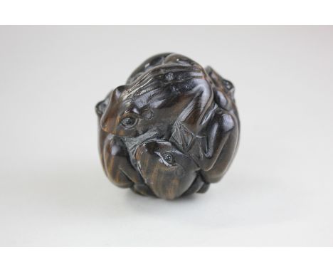 A Japanese carved wood netsuke of toads wrapped up in a ball, 6cm