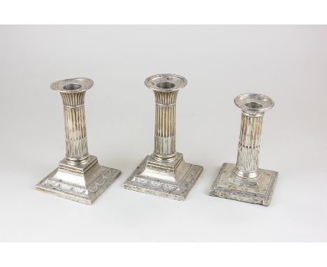 A pair of Victorian silver Corinthian column candlesticks with reeded stem and embossed pattern, by William Hutton & Sons, Lo