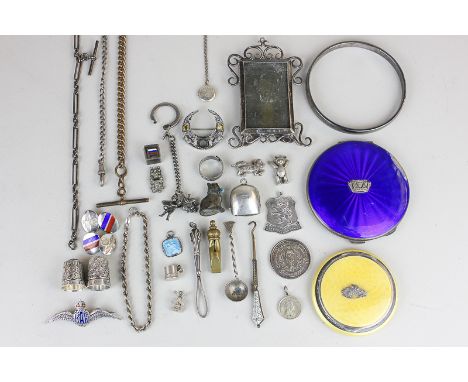 A small silver easel photograph frame, two silver thimbles, a silver pocket watch chain, a silver bangle, a yellow enamelled 